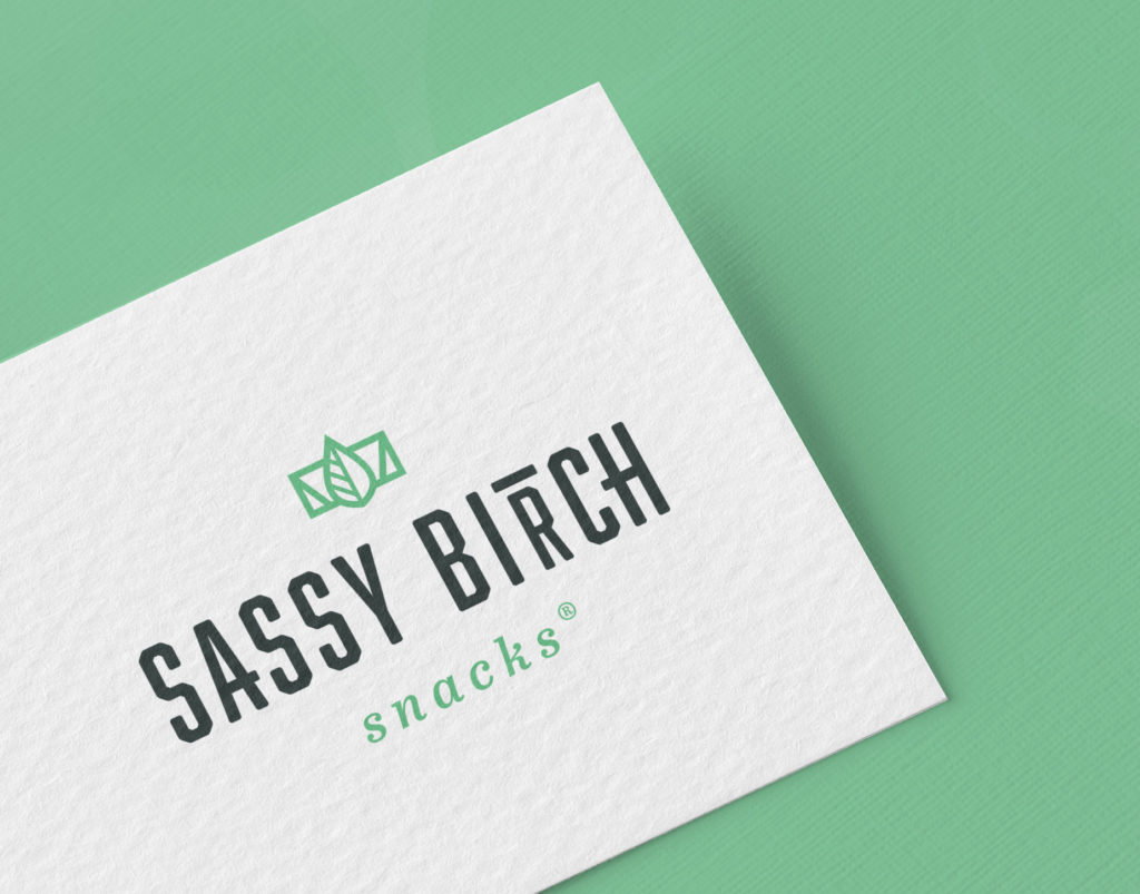 Logo design on a business card for vegan snack company